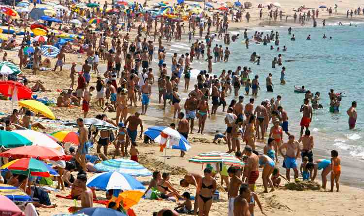 Una spiaggia in estate prima della pandemia Covid-19