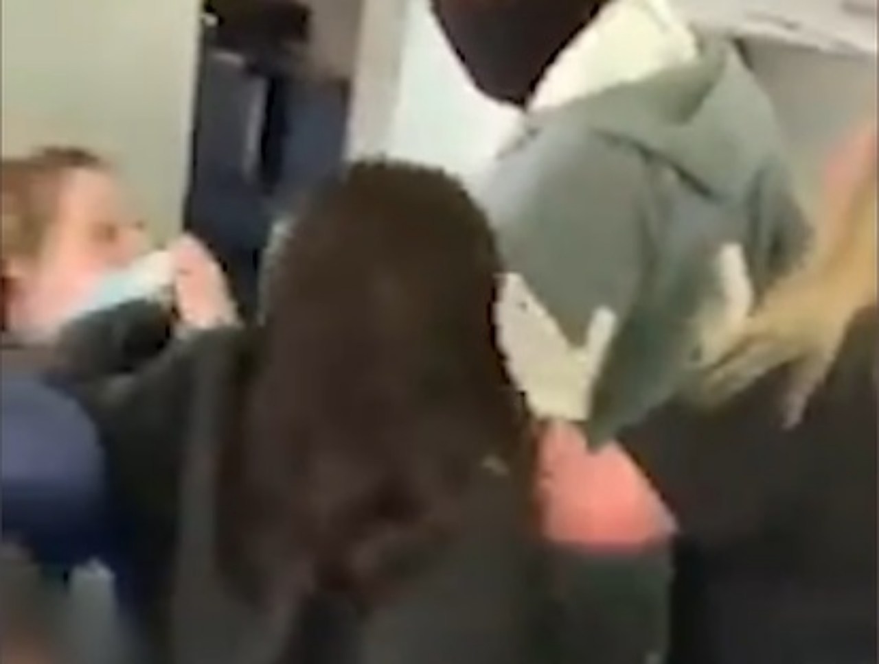 Lite tra hostess e passeggera per l'uso della mascherina